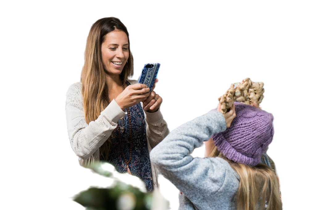 The image above with the woman and girl taking a photo in a grocery store is displayed with the background removed.