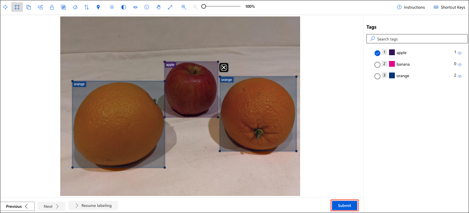 An image with bounding boxes around three objects, two oranges and an apple, is displayed.